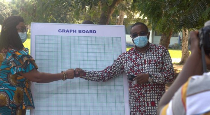 Member of Parliament for South Tongu Hon. Kobena Mensah Woyome handing over graph boards to Ms. Evelyn Araba Zentey, South Tongu District Director of Education
